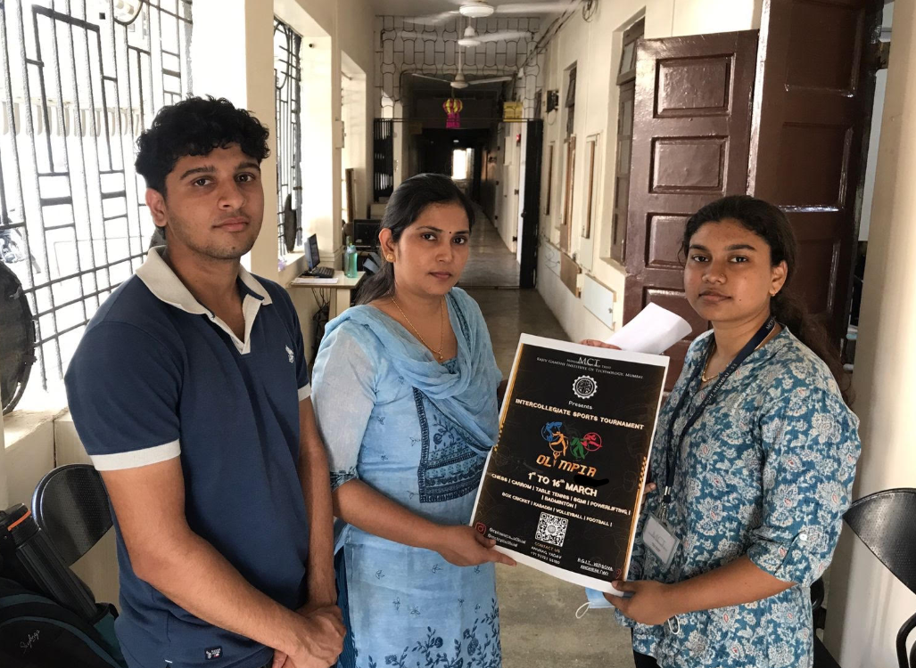 Volunteers at Olympia Sports Tournament with RGIT Mumbai holding tournament poster
